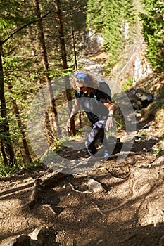 Hiker lady with backpack alone on the trail