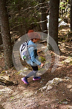 Hiker lady with backpack alone on the trail