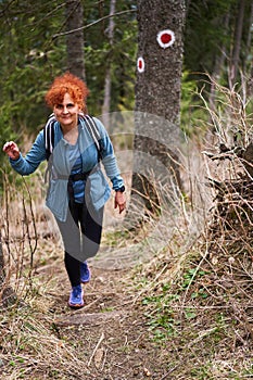 Hiker lady with backpack alone on the trail