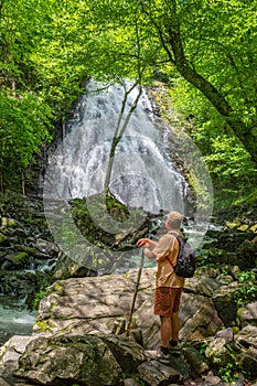 Hiker looking at beautiful waterfall in North Carolina forest