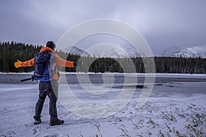 Hiker looking at Bierstadt Lake winter time