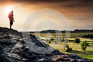 Hiker looking at the Nadab floodplains from the top of Ubirr rock. Australia photo