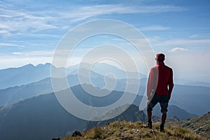 Hiker looking over the mountain ridges photo
