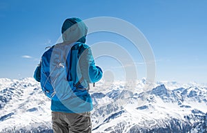 Hiker looking at snowy mountain