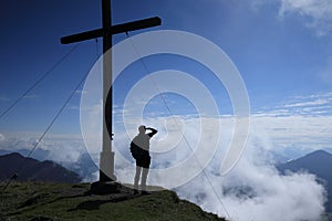 Hiker is looking to the mountains