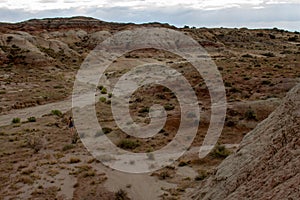 Hiker looks across desert landscape at the Bisti Badlands in New Mexico