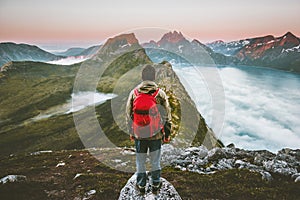 Hiker man exploring sunset mountains with backpack