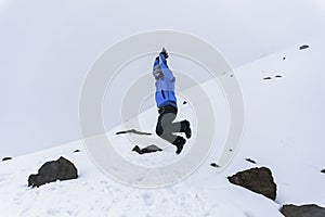 hiker man jumping on the base of chimborazo Mountain in ecuador