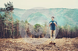 Hiker man standing in the forest