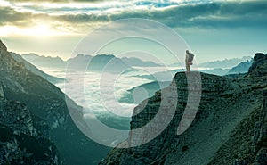 Hiker man standing at the rock edge photo