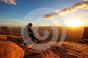 Hiker meets sunset at Grand view point in Canyonlands National p