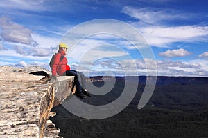 Hiker on mountain ledge - risk freedom adventure s