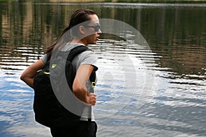 Hiker in the mountains rests at a lake