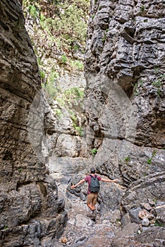 Hiker in a narrow trail of Imbros gorge, Crete Greece photo