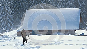 Hiker photographer taking pictures of snowy nature in winter mountains.