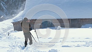 Hiker photographer taking pictures of snowy nature in winter mountains