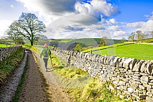 Hiker in a pink hat, heading towards Thor\'s Cave, Staffordshire.