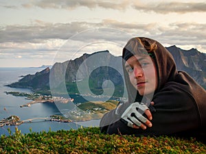 Hiker portrait with Reinefjorden fjord in the background, Lofoten, Norway