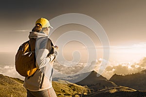 Hiker portrait of young woman with backpacker hiking in high mountains.