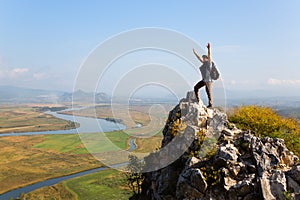 Hiker raises his arms up and screaming with delight