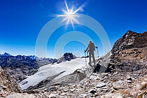 Hiker reaches a high mountain pass, Italian Alps, Val D`Aosta, I