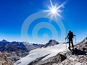 Hiker reaches a high mountain pass, Italian Alps, Val D`Aosta, I