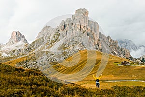 Hiker reaching hands enjoys exploring mountain on Pass Giau