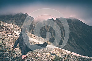 Hiker relaxing on top of a mountain. Instagram stylisation