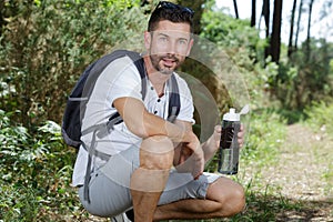 hiker relaxing by tree on fall journey