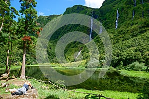 A hiker resting after a great hike and enjoying Great view, Flores, Azores - the green paradise in the Atlantic Ocean