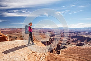 Hiker rests in Canyonlands National park in Utah, USA