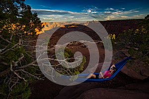 Hiker rests on a hammock admiring the sunset East Fork Shafer Ca