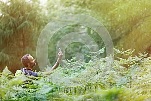 Hiker searching a mobile phone signal, being lost