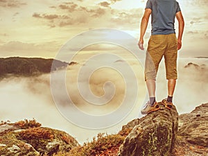 Hiker on sharp cliff of sandstone rock in rock empires park