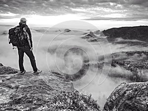 Hiker on sharp cliff of sandstone rock in rock empires park