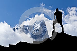 Hiker silhouette man in mountains