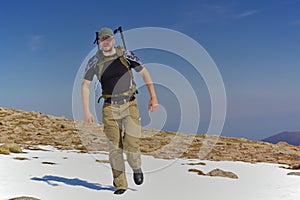 Hiker in a snowfield in the mountains