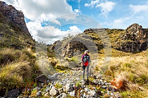 Hiker in Snowy Mountains walking through a dry gorge