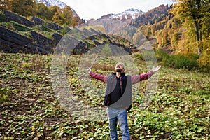 Hiker standing in front of a majestic mountain landscape