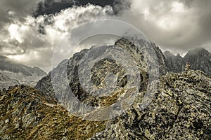 Hiker standing on the hill and looking on mountains