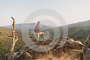 Hiker standing on peak of rock