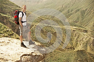 Hiker Standing On Top Of Mountain