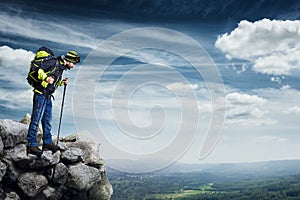 Hiker standing on the top of rock