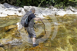 Hiker standing in the water photo