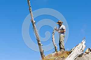 Hiker stands on top of Castle Peak