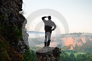 Hiker stands on top of the mountain sunrise