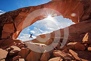 Hiker stay below Skyline arch in Arches National Park in Utah, USA