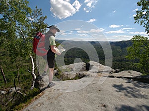 Hiker stay close to edge above forest valley. Travel and hike fashion