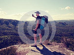 Hiker stay close to edge above forest valley. Travel and hike fashion