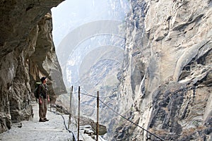 Hiker on Steep Mountain Path